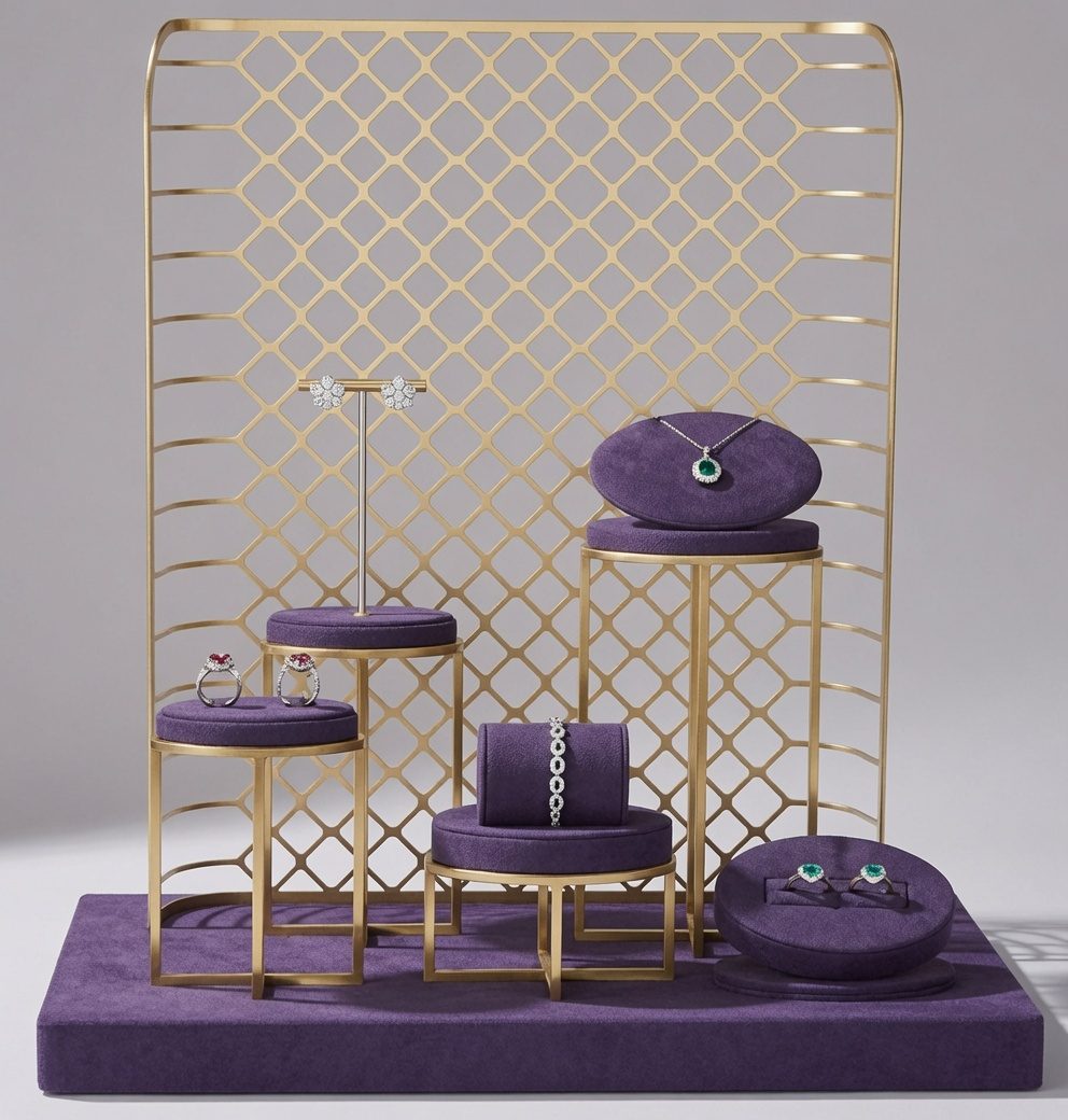 Gold and velvet jewelry display set with necklace bust and pedestals